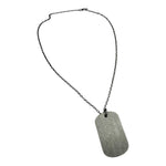 Necklace with a textured metal tag on a white background