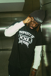 Person wearing a black 'Property of XXL'